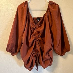 NWT 1XL top 100% polyester. Rust Brown in color. Ruching to back.